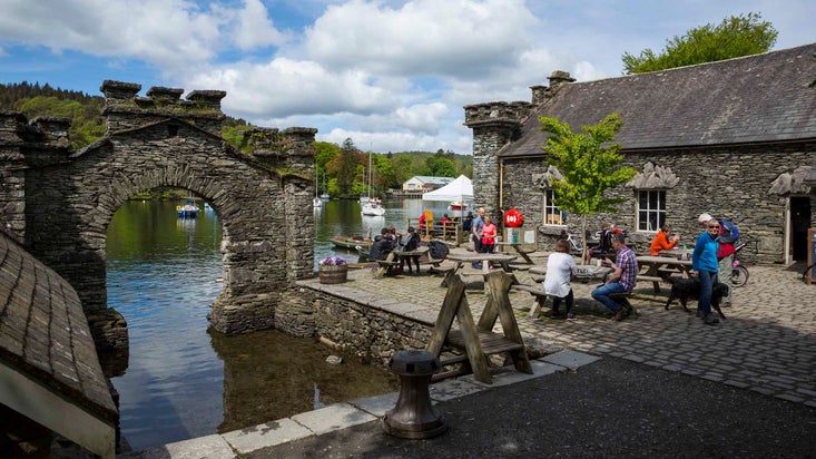 Visitors outside the Boathouse cafe in spring at Fell Foot, Cumbria